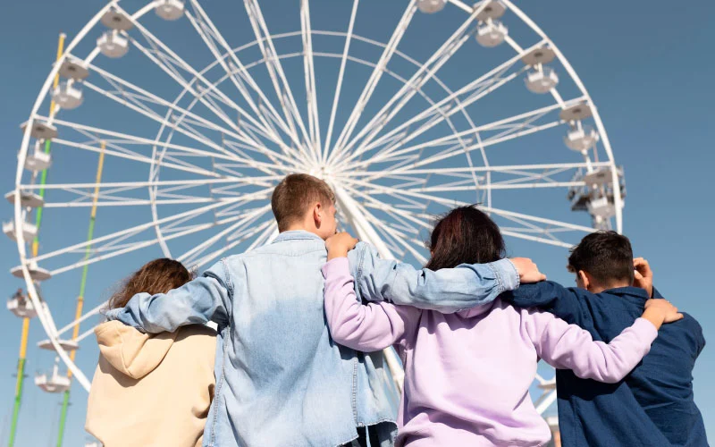 Crowds enjoying carnival rides and showbags at the Royal Adelaide Show with Ferris Wheel in the background